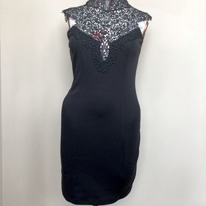 Black fitted dress with high neck lace details.